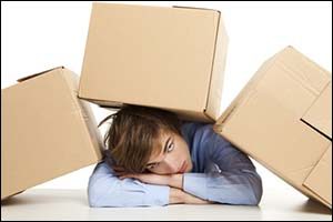 person laying under cardboard boxes